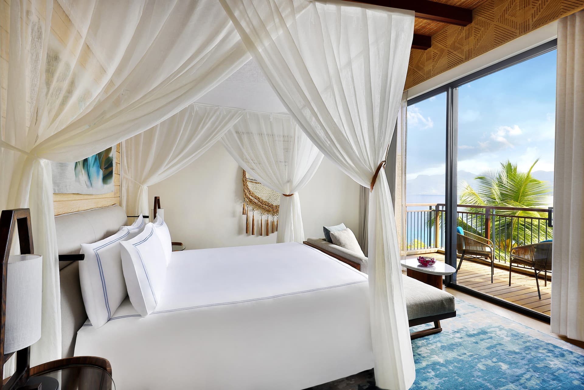 Four-poster canopy bed suite with ocean views at a Seychelles cliff house