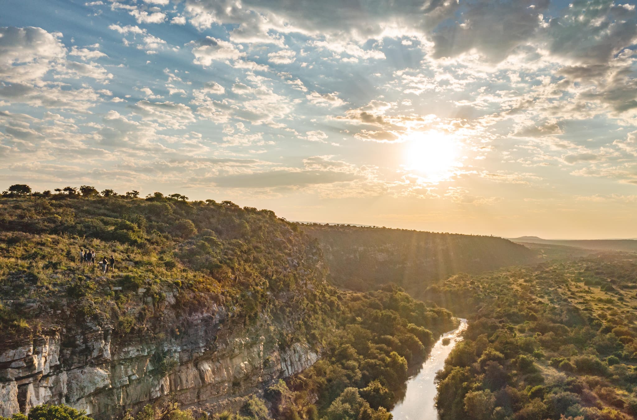Great Fish River canyon at sunset with hikers on the cliff edge