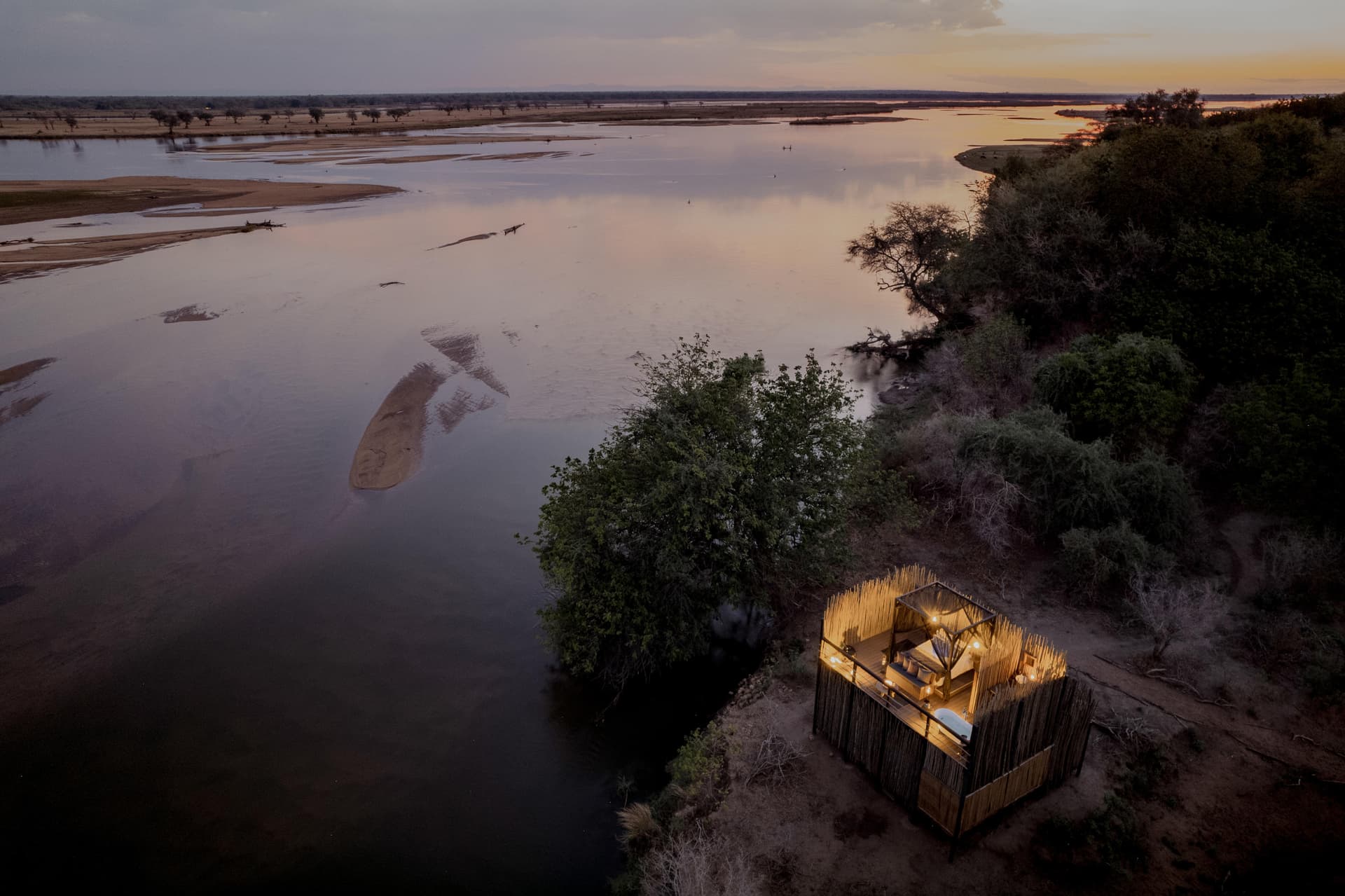 Aerial view of a star bed sleep-out on the Zambezi riverbank at twilight