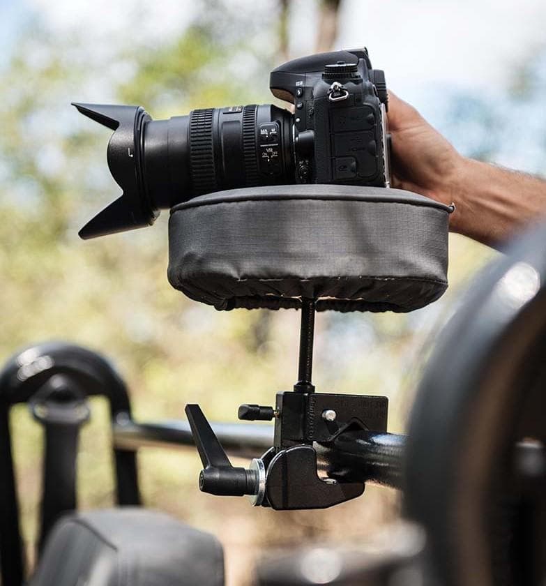 Professional DSLR camera mounted on a safari vehicle beanbag support